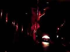 Elegant long-legged girl is dancing in miniskirt in the night club